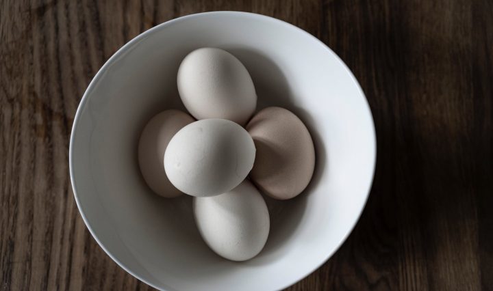 white raw eggs in bowl on table