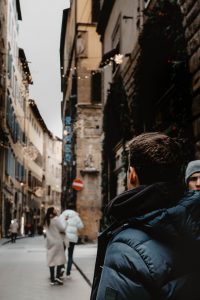 man in black jacket walking on street