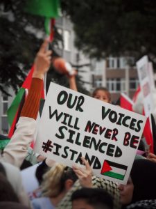 a sign that reads our voices will never be silenced israel