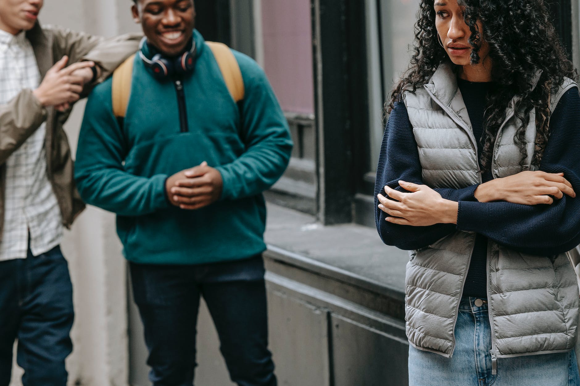 multiracial friends bullying female on street