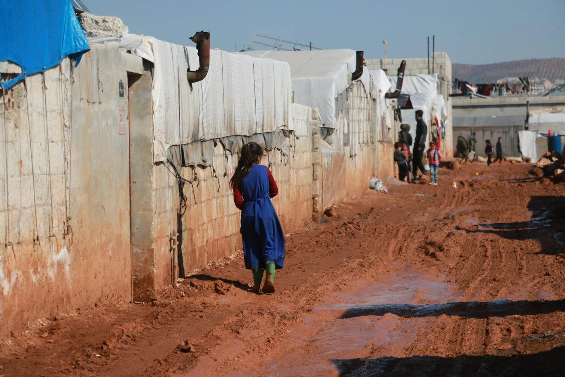 poor children near brick shabby houses of countryside