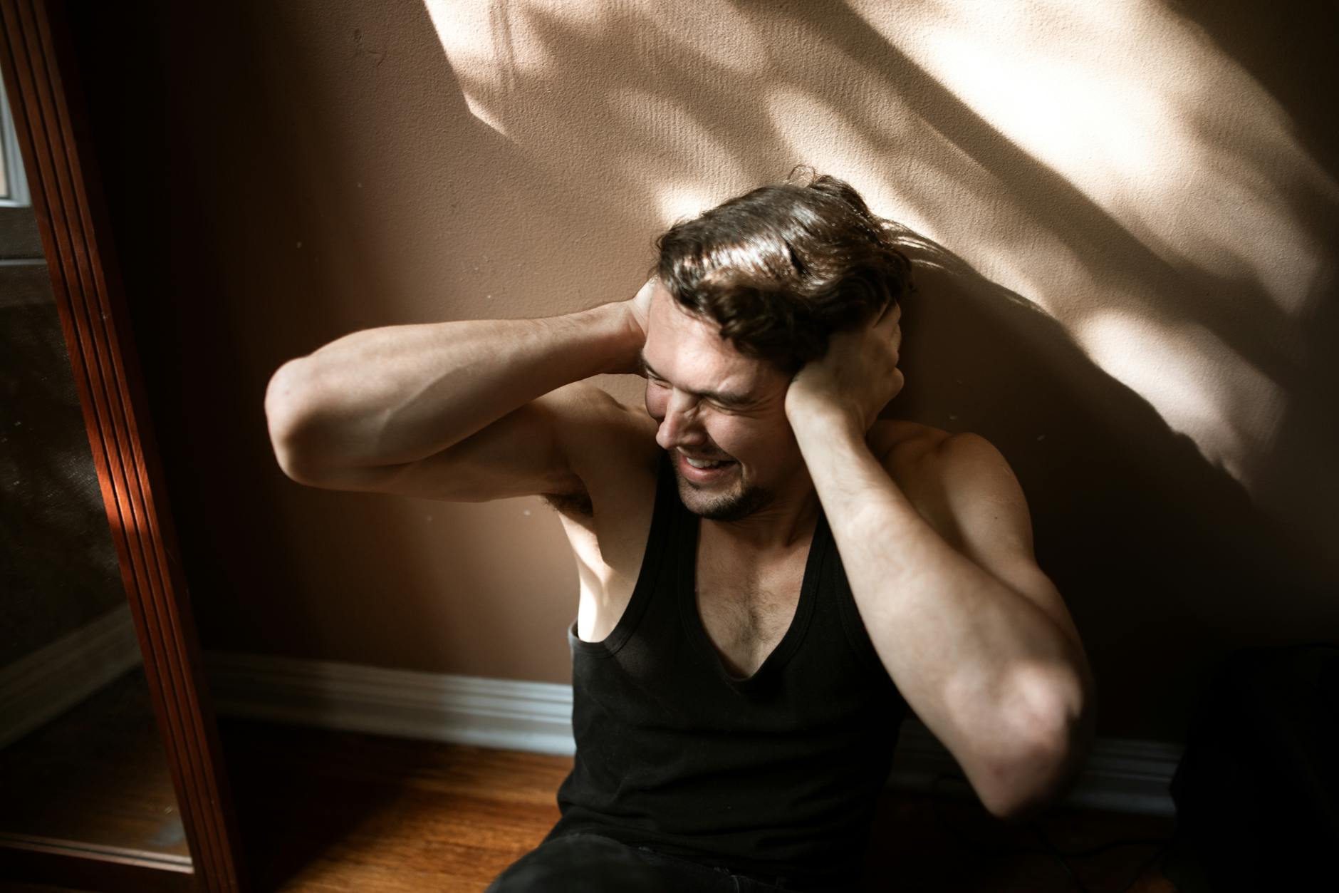 a man covering his ears