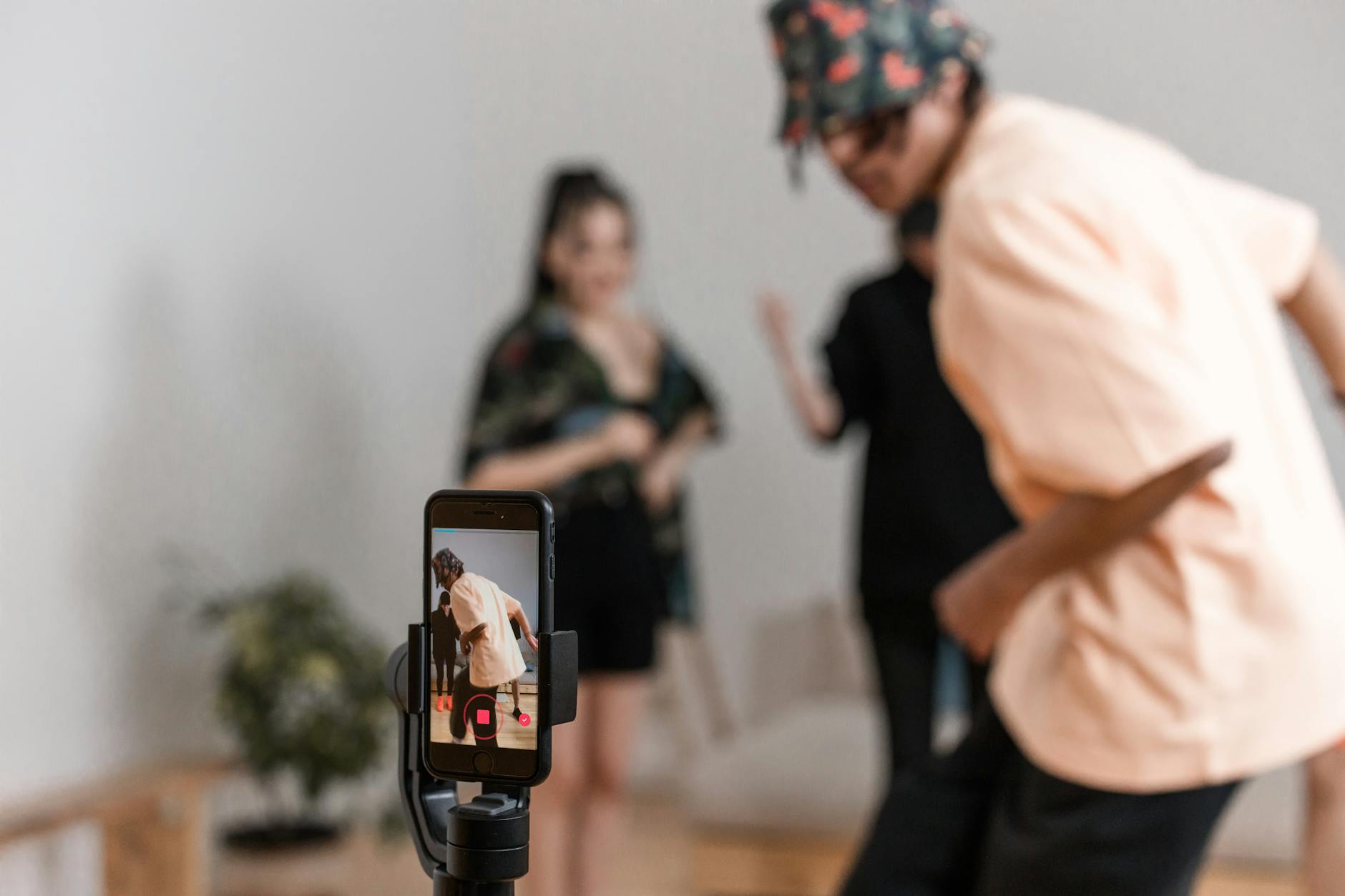 a man dancing in front of a smartphone